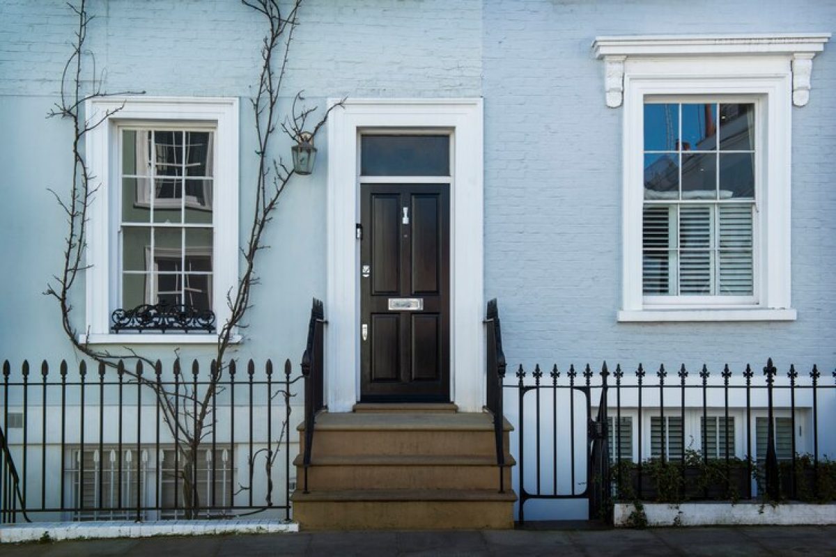 front-view-front-door-with-blue-wall-plants_23-2149360640