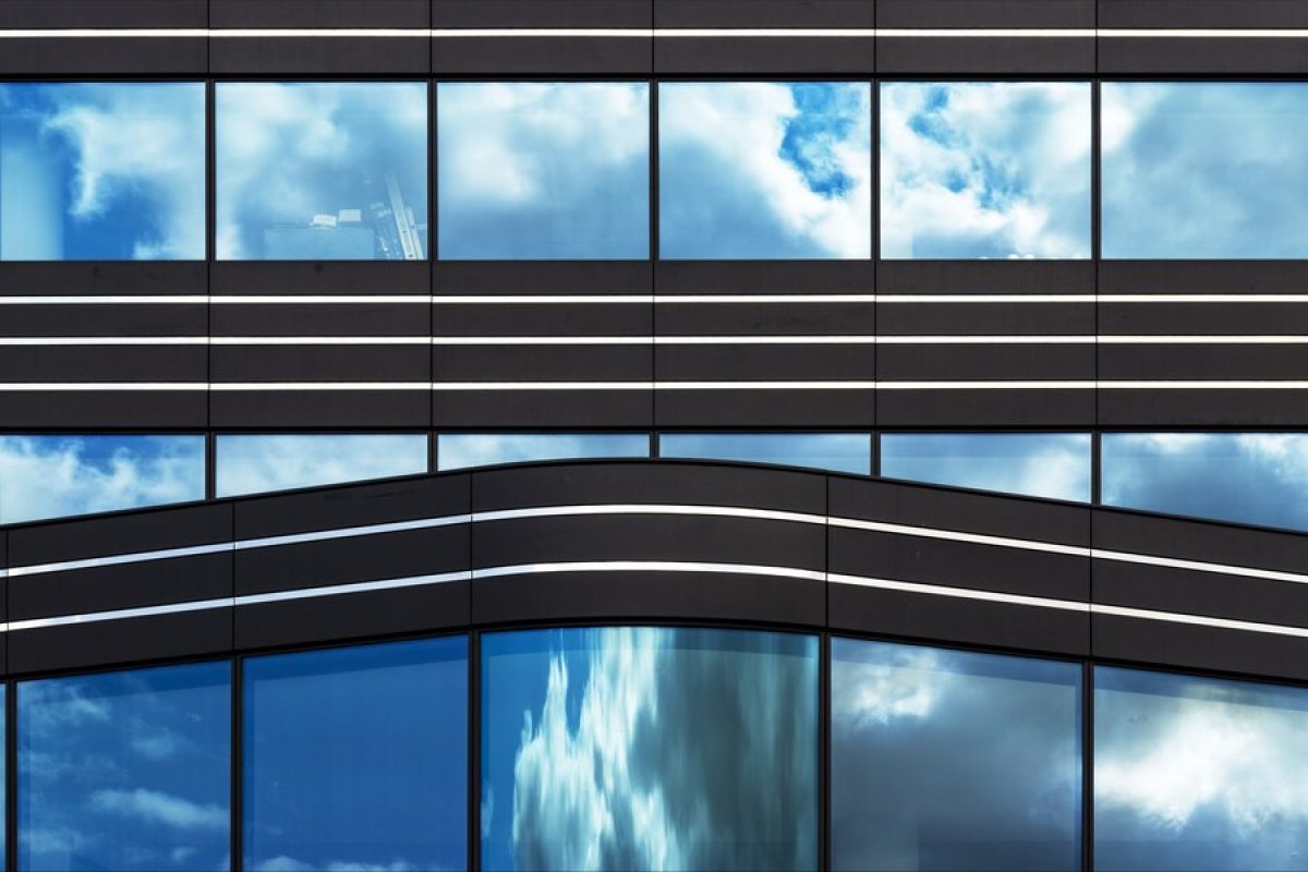 modern-building-with-glass-windows-silently-witnessing-life-big-city_181624-7240